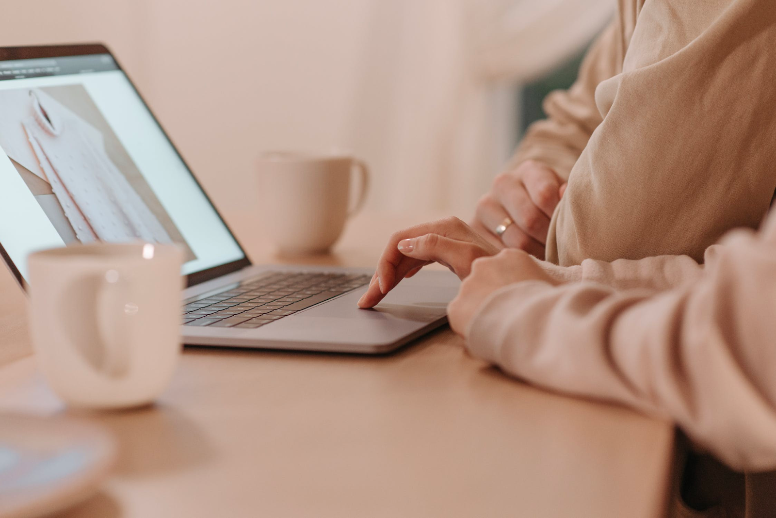 a woman using a laptop on a coffee table