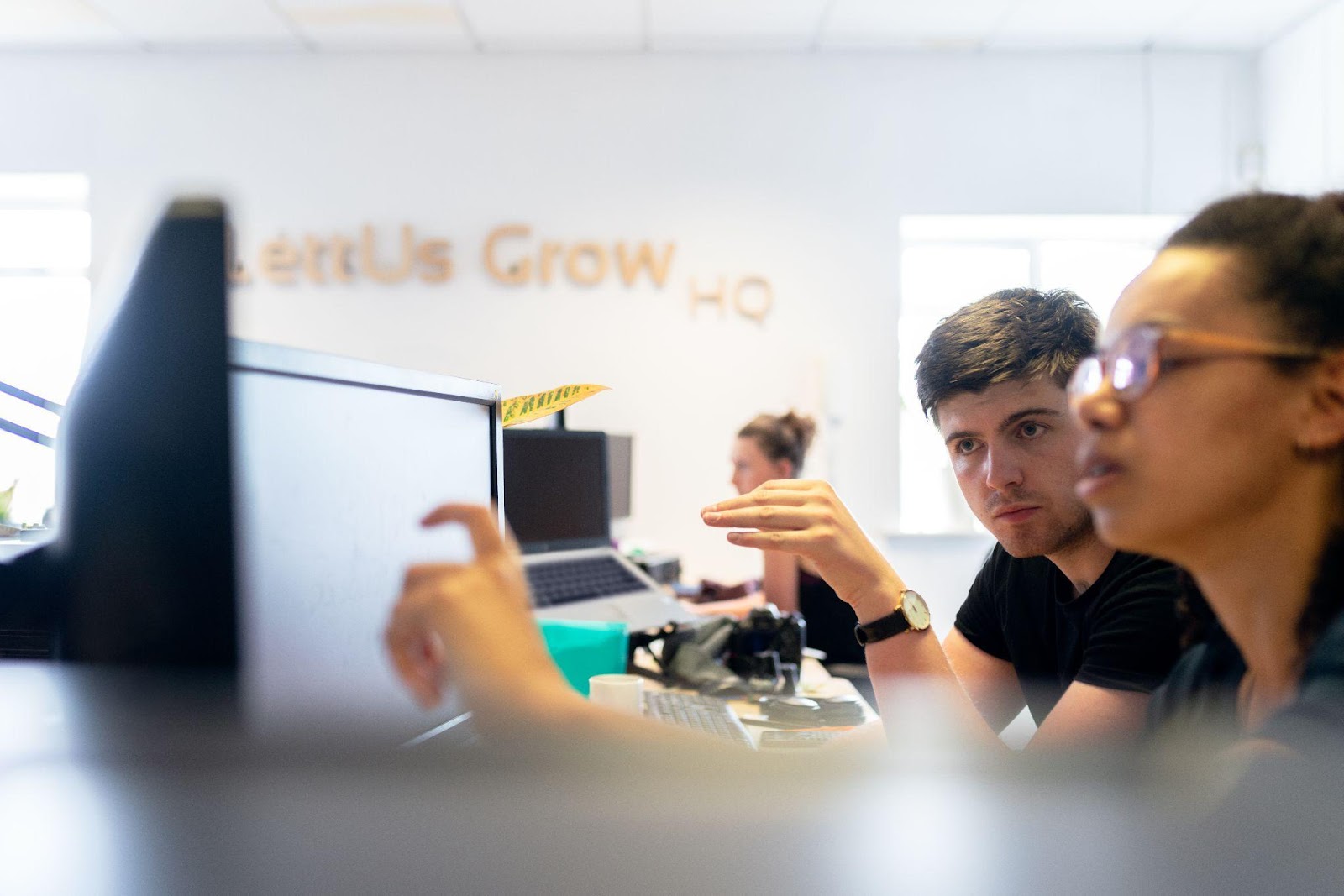 two workers looking a computer monitors