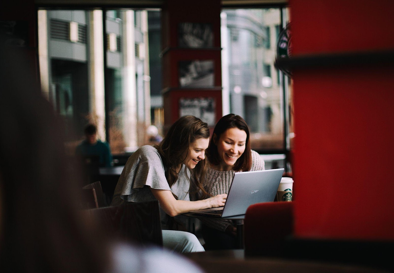 two people looking at a laptop 