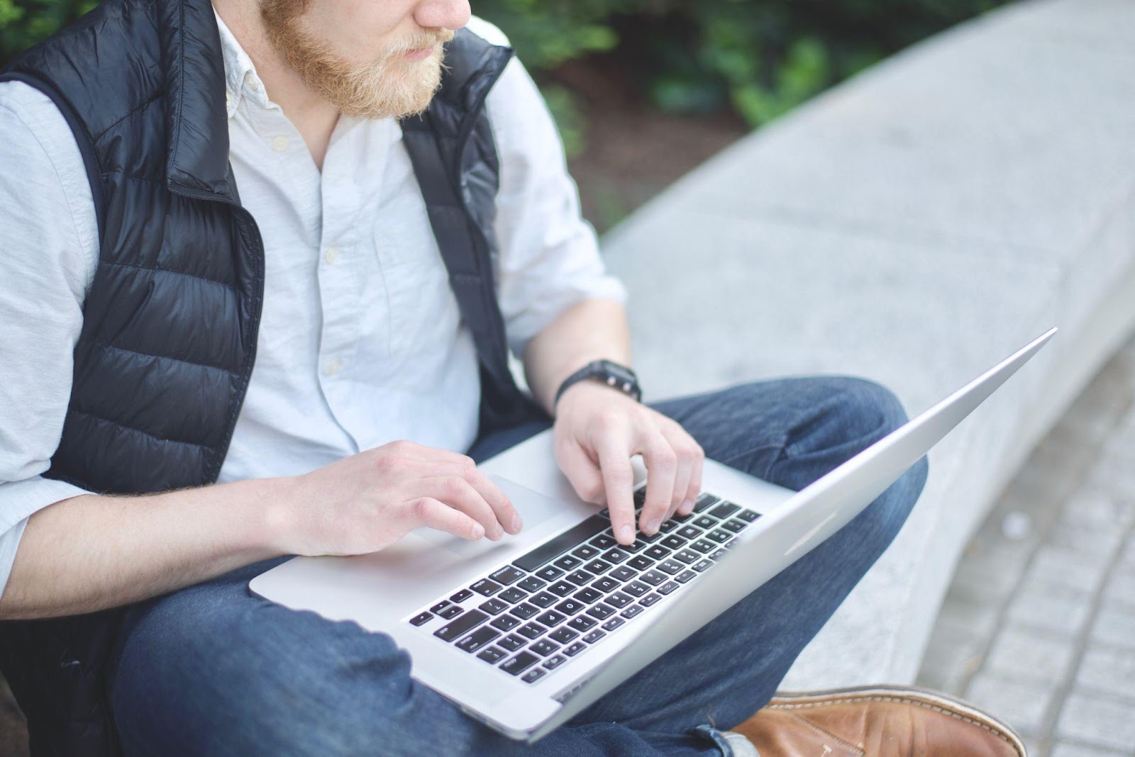 a man typing on a laptop