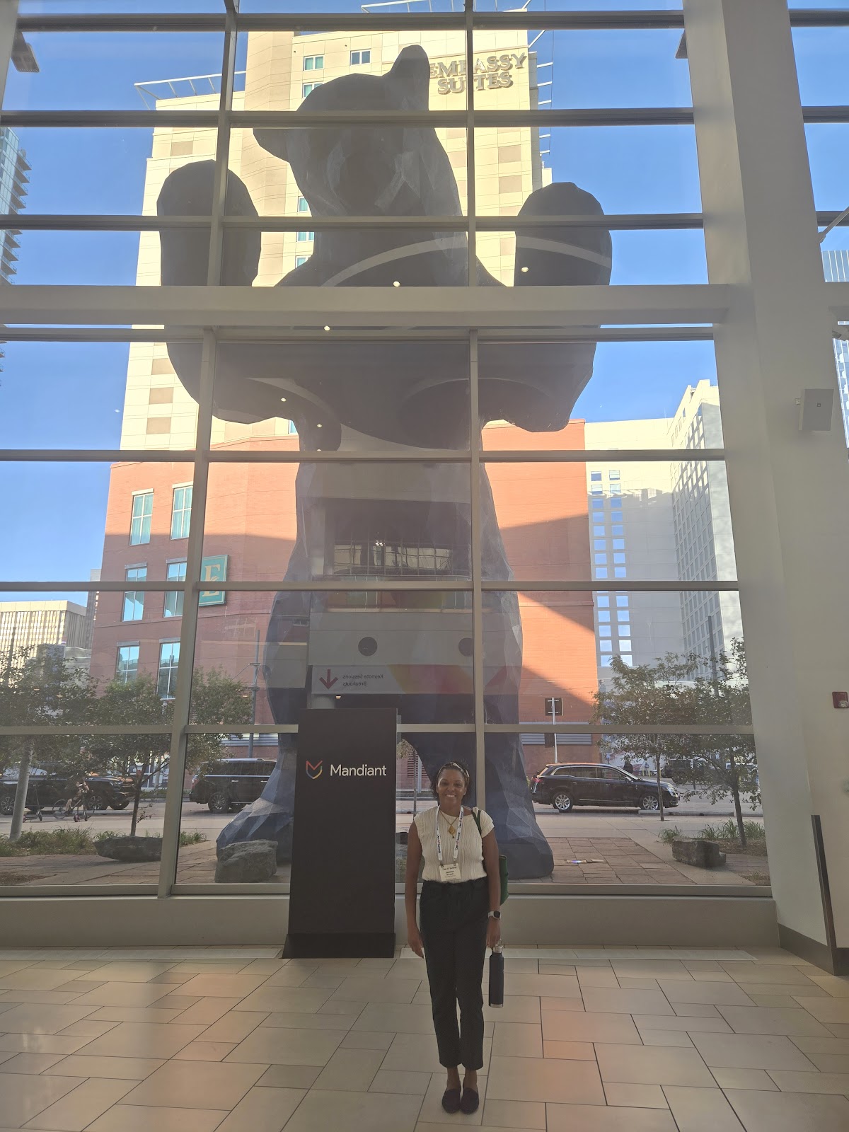 The Data Love Co. co-founder stands in the Colorado Convention Center atrium in front of the big blue bear